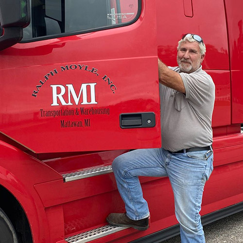 driver posing with his RMI truck