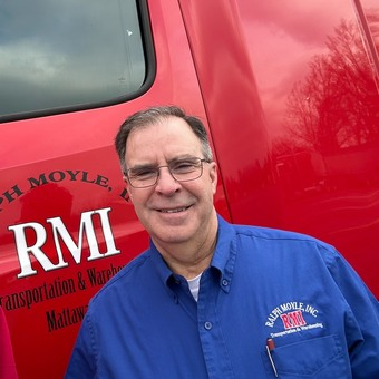 driver standing near RMI truck