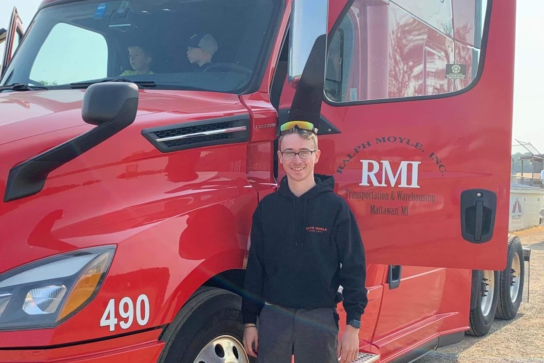Ralph Moyle driver standing next to his truck
