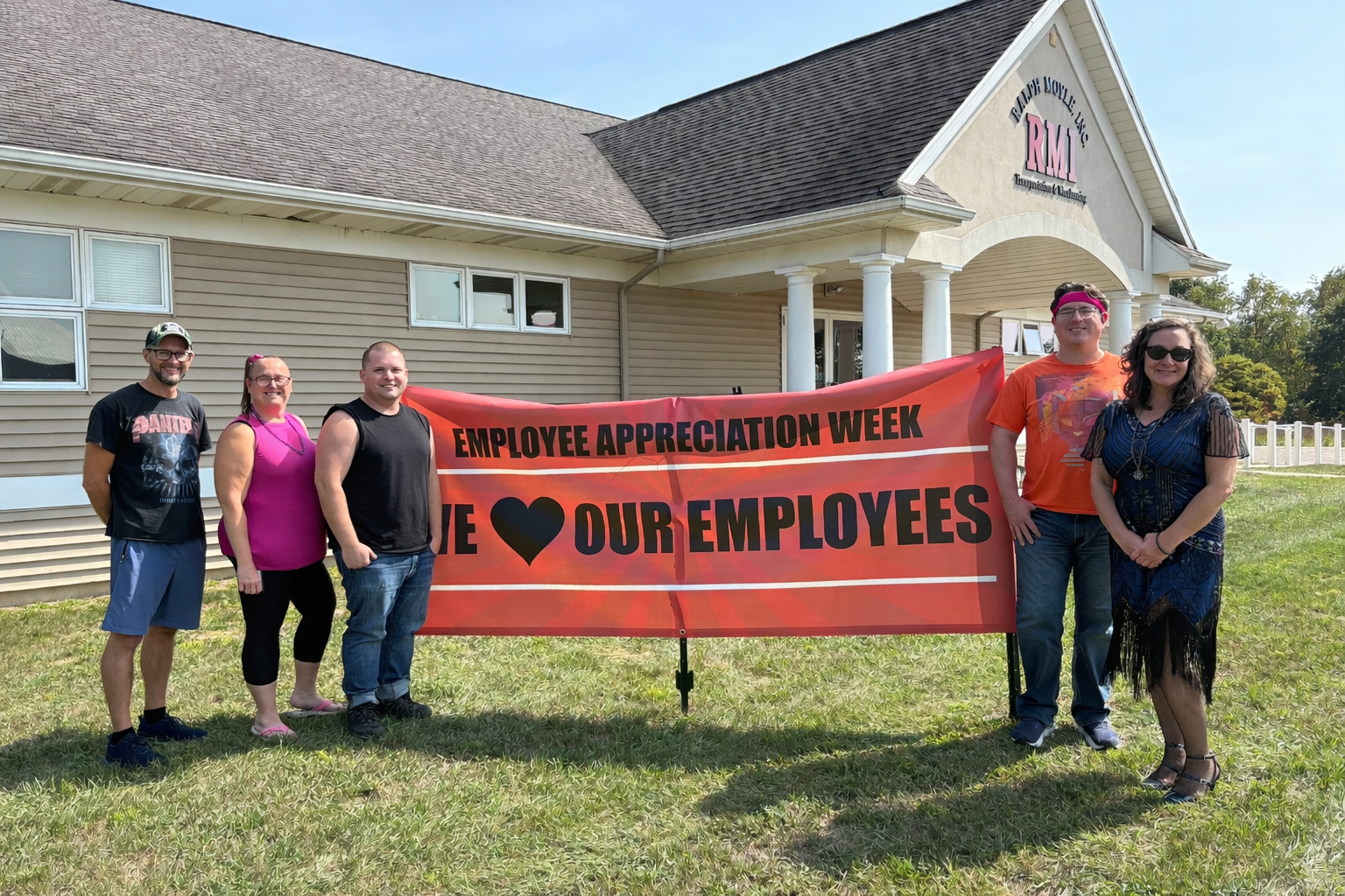 Ralph Moyle Employees standing next to Appreciation Week banner